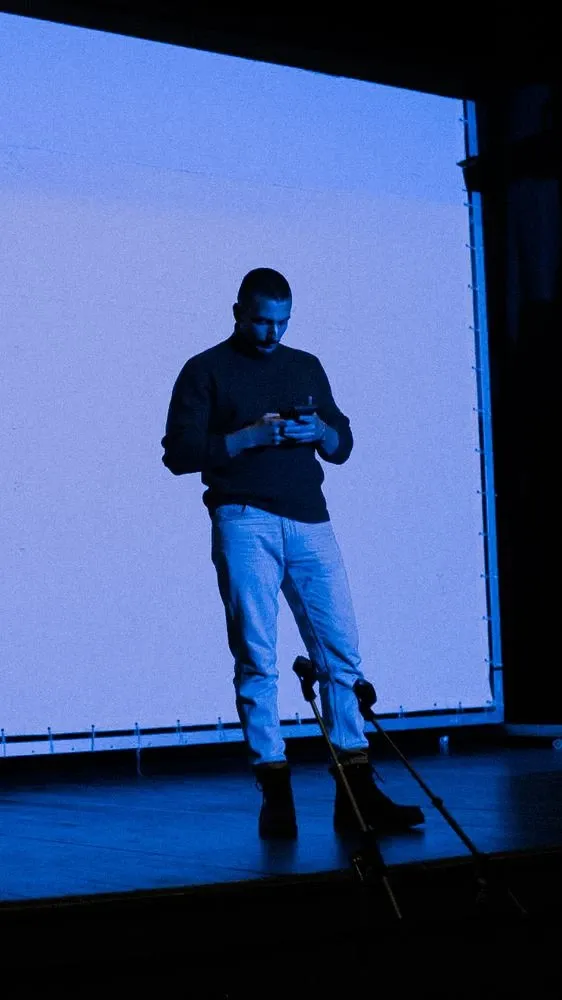 Founder of Nothin on stage, lit in deep blue